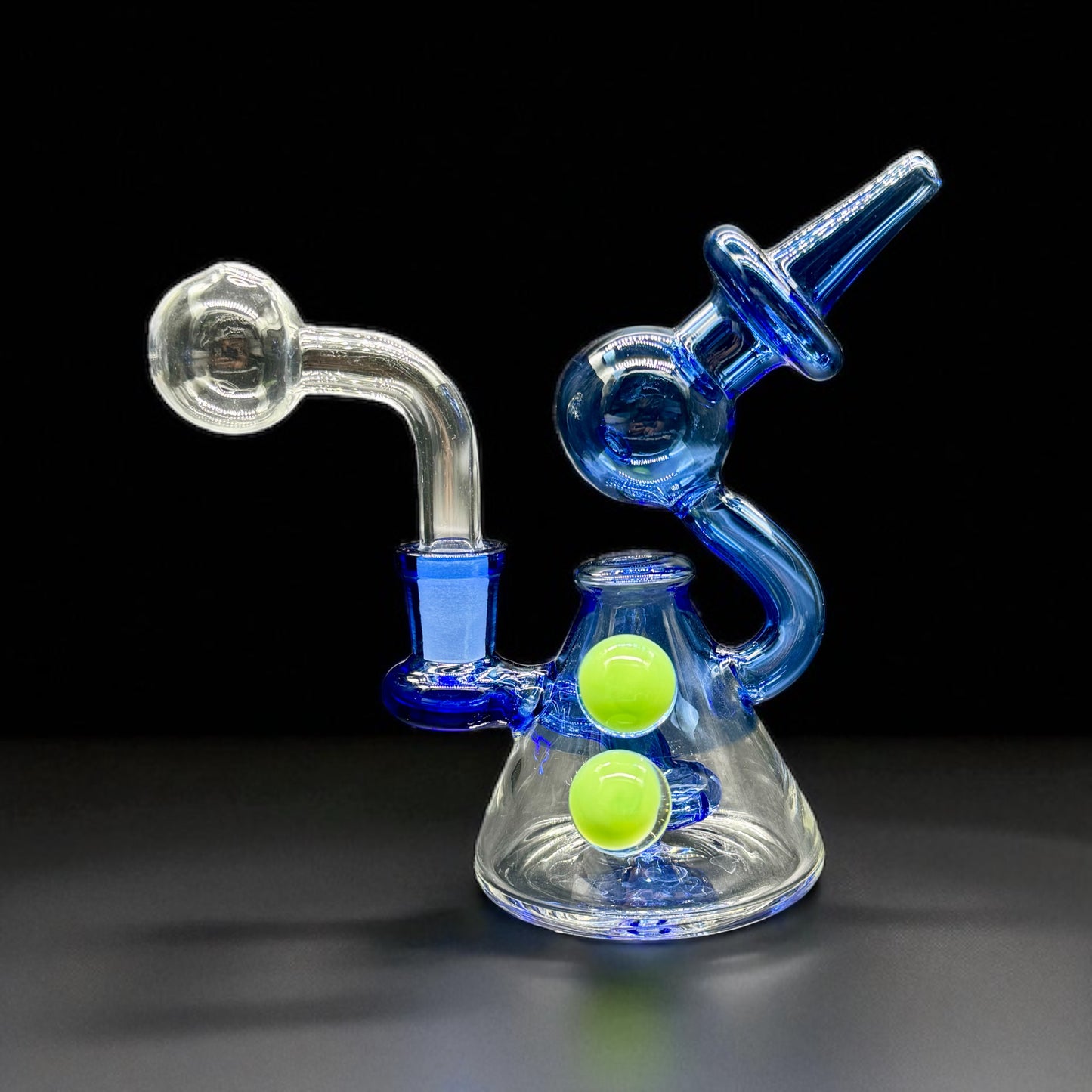 Glass water pipe with blue and clear design on a black background