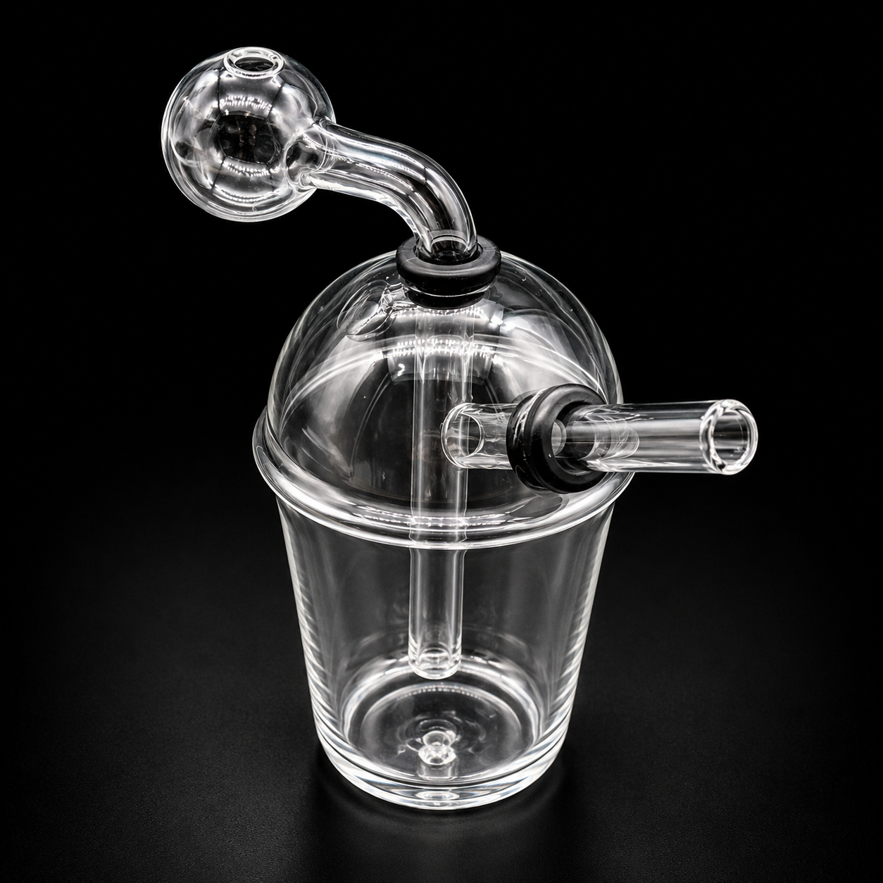 Clear glass smoking device with a handle on a black background