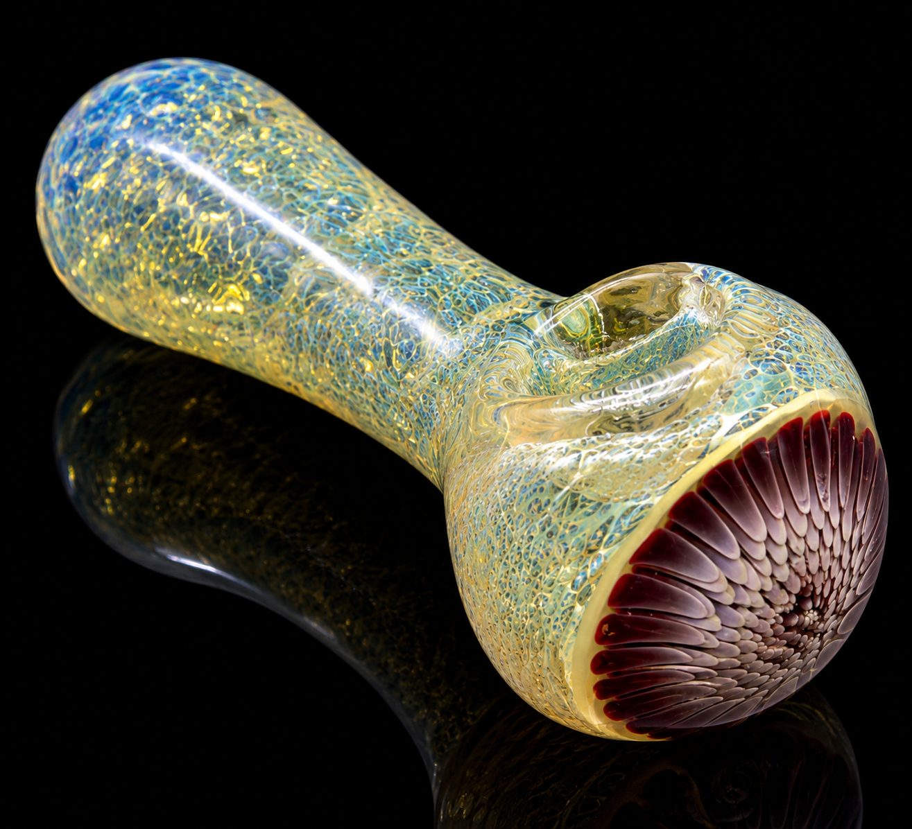 Glass pipe with textured surface and colorful interior on a reflective black surface