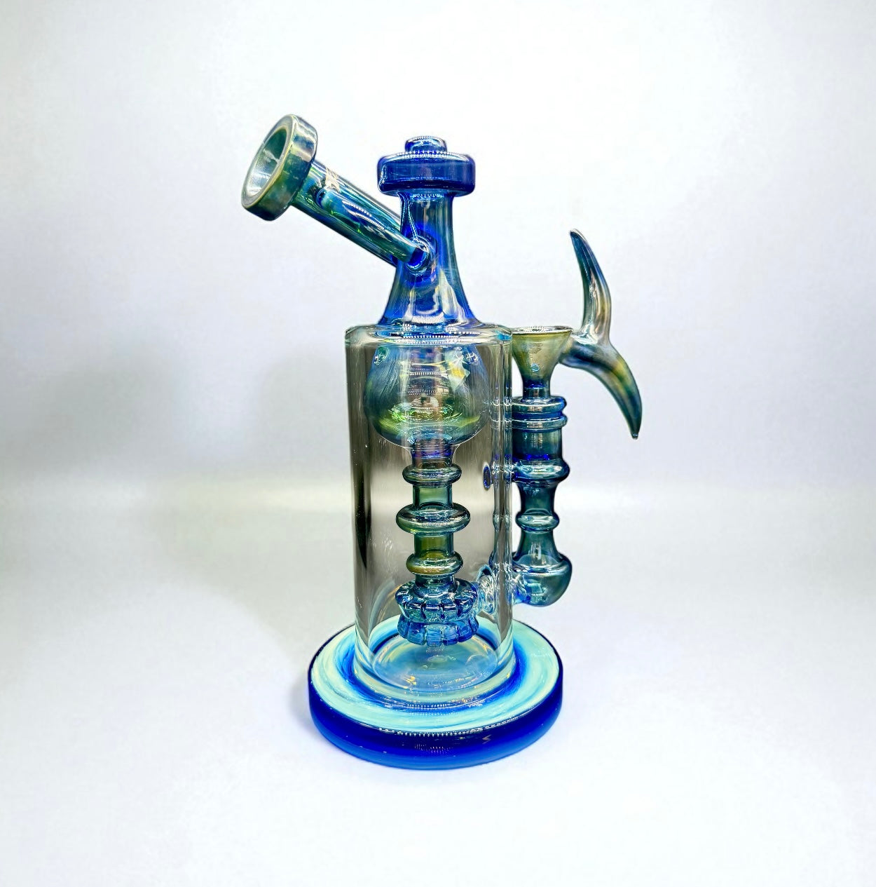 Glass water pipe with blue and green design on a white background