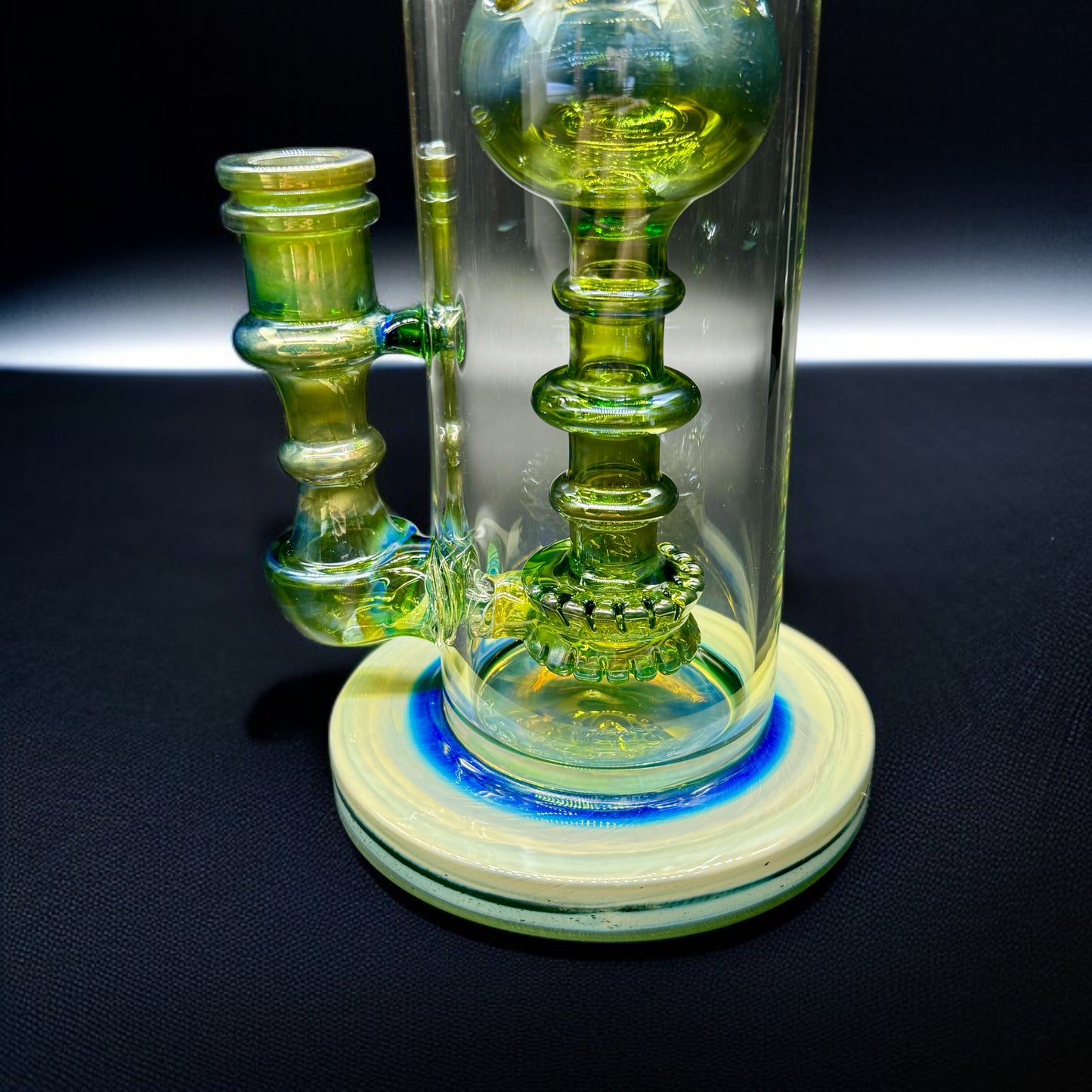 Artistic glass water pipe featuring a recycler design and 14mm dry herb bowl