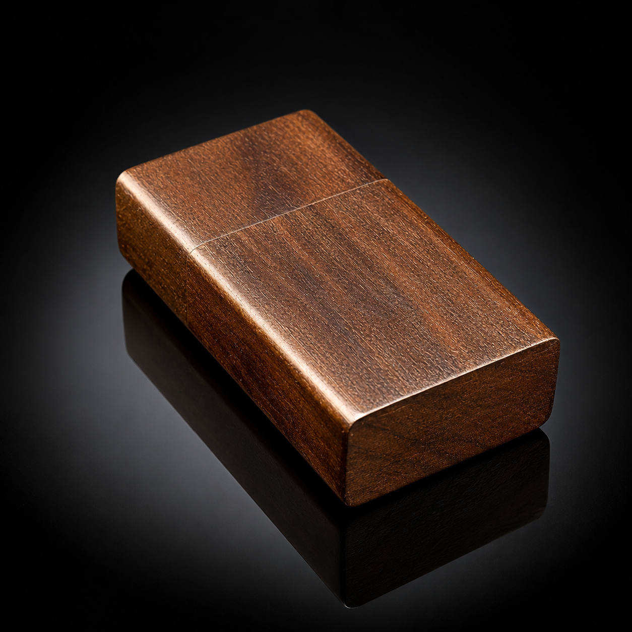 A rectangular wooden box with rounded corners, featuring a rich brown wood grain pattern, displayed on a reflective black surface.