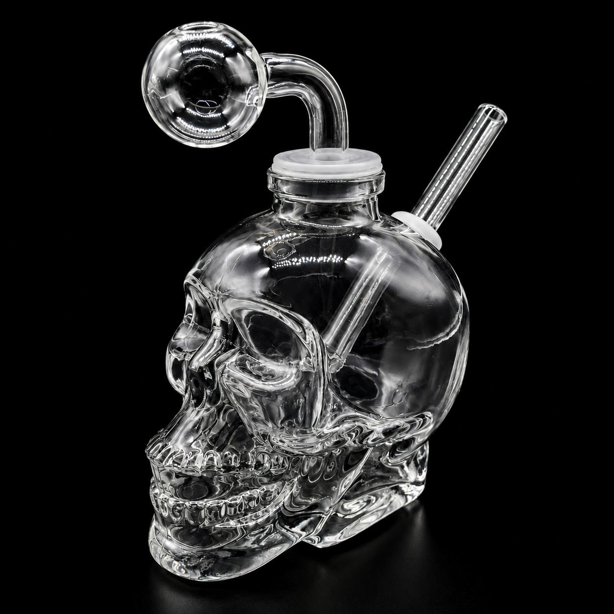 Clear glass skull-shaped smoking device with a hose on a black background