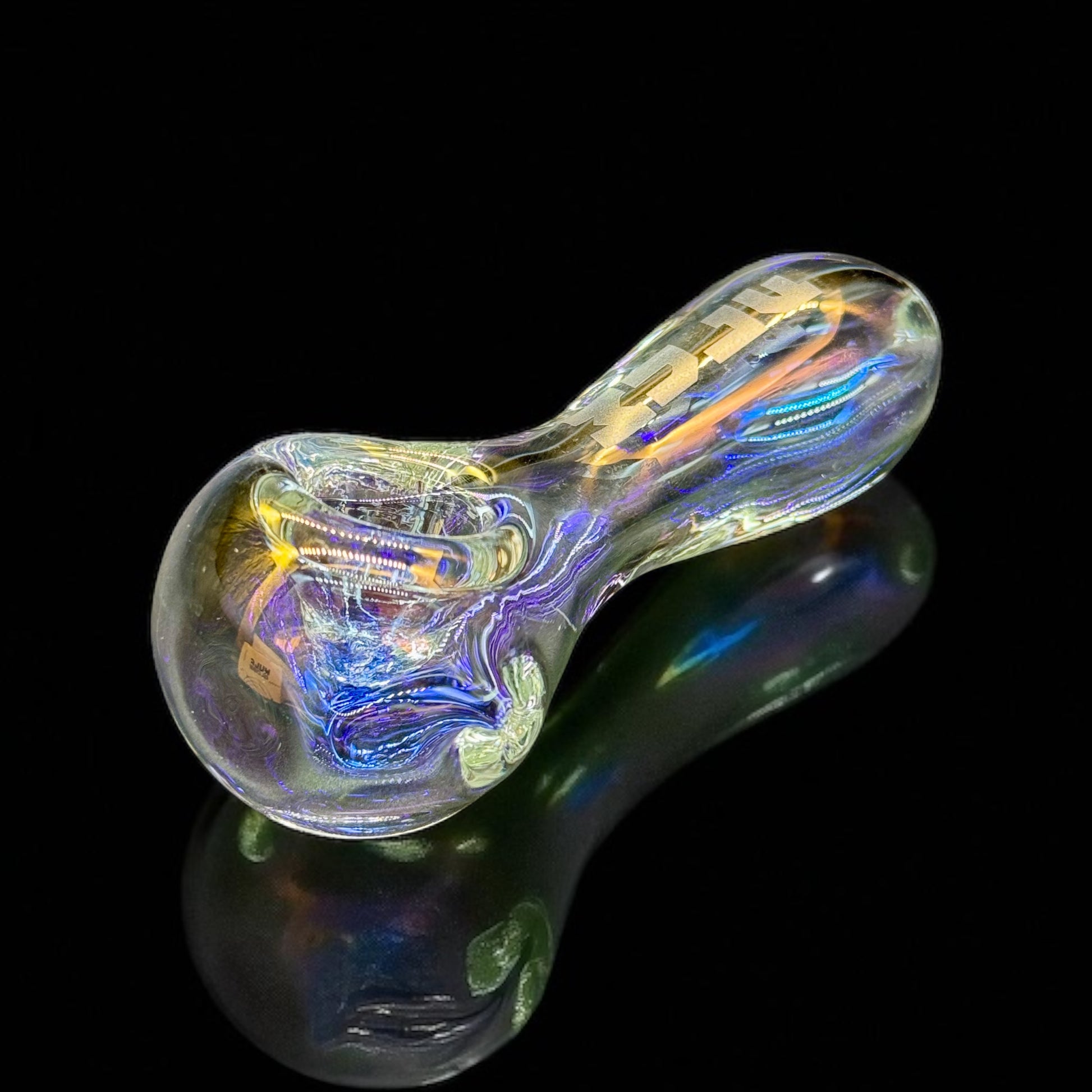 Glass pipe with colorful iridescent finish on a black background