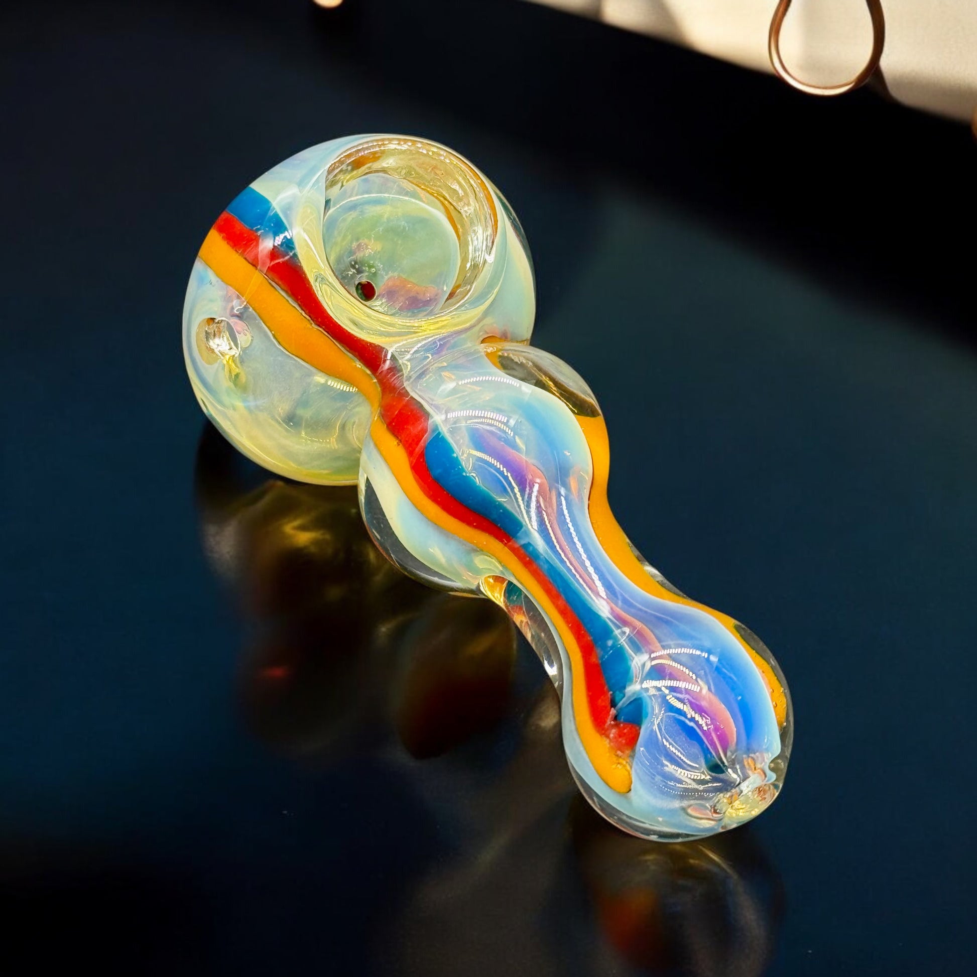 Top-down view of USA-made glass pipe with vibrant color swirl design.