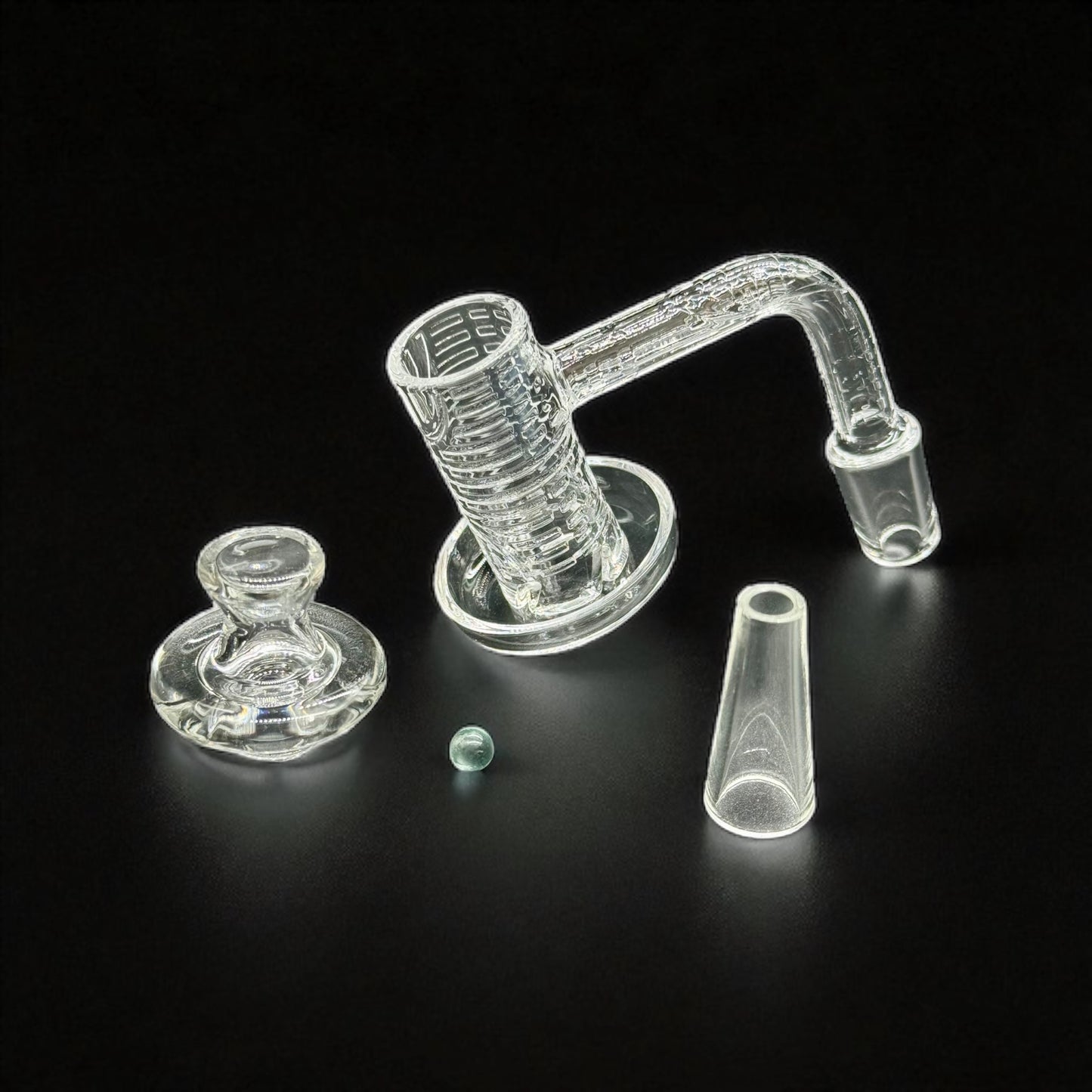 Clear quartz banger  accessory with multiple components on a black background