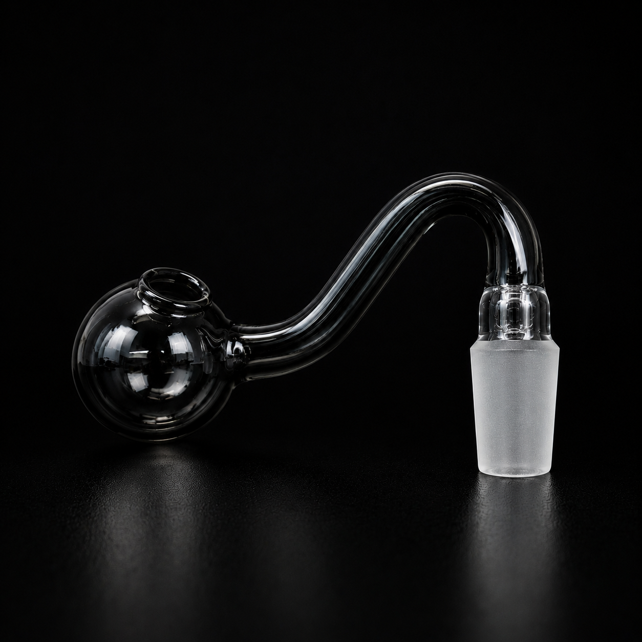 Glass smoking pipe on a black background