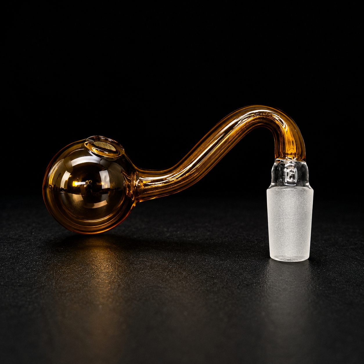 Glass pipe with amber bowl and clear chamber on a black background
