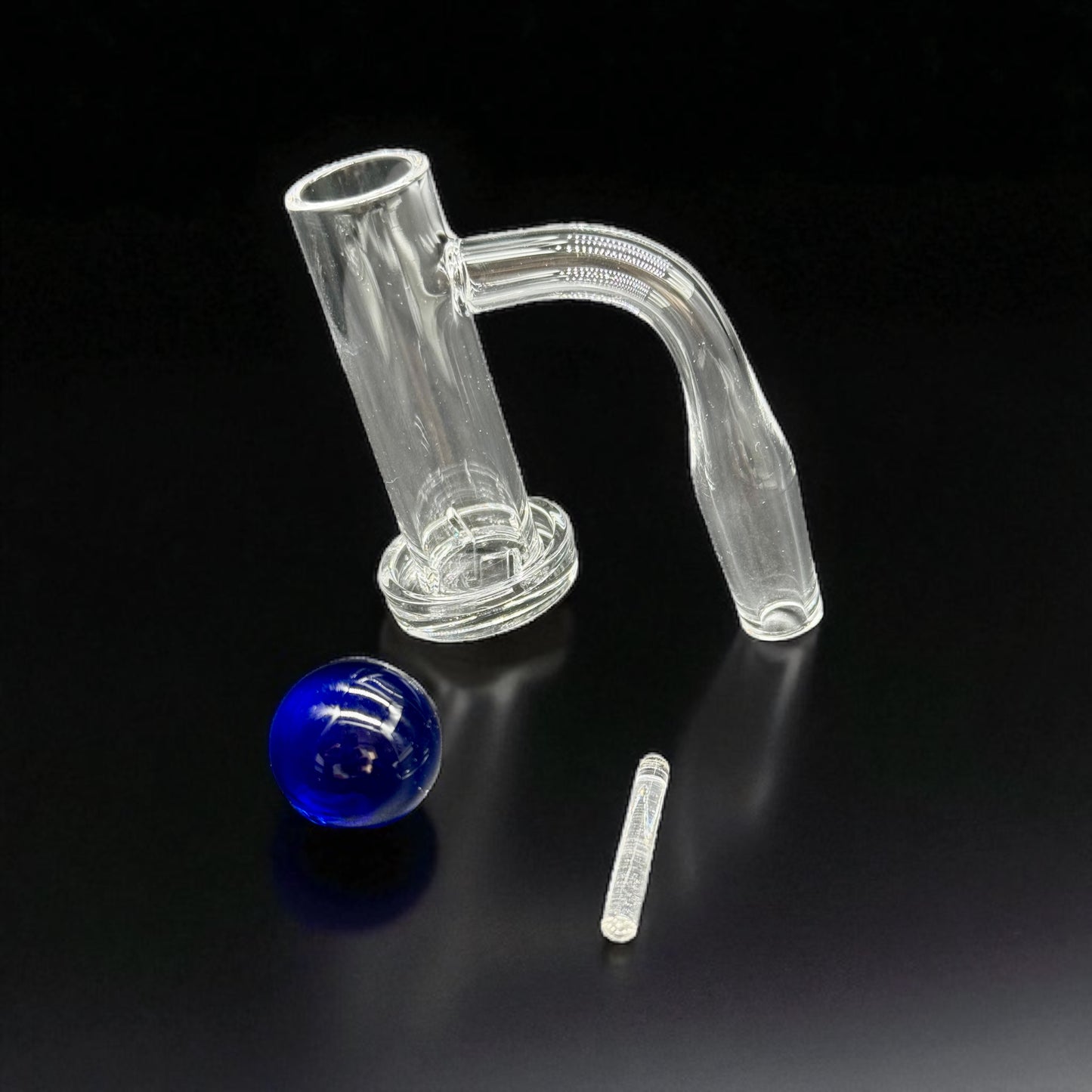 Clear quartz banger  with blue marbles on a black background