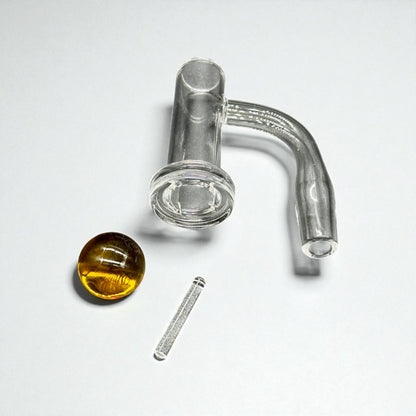 Glass smoking accessory with a yellowish liquid and a metal piece on a white background