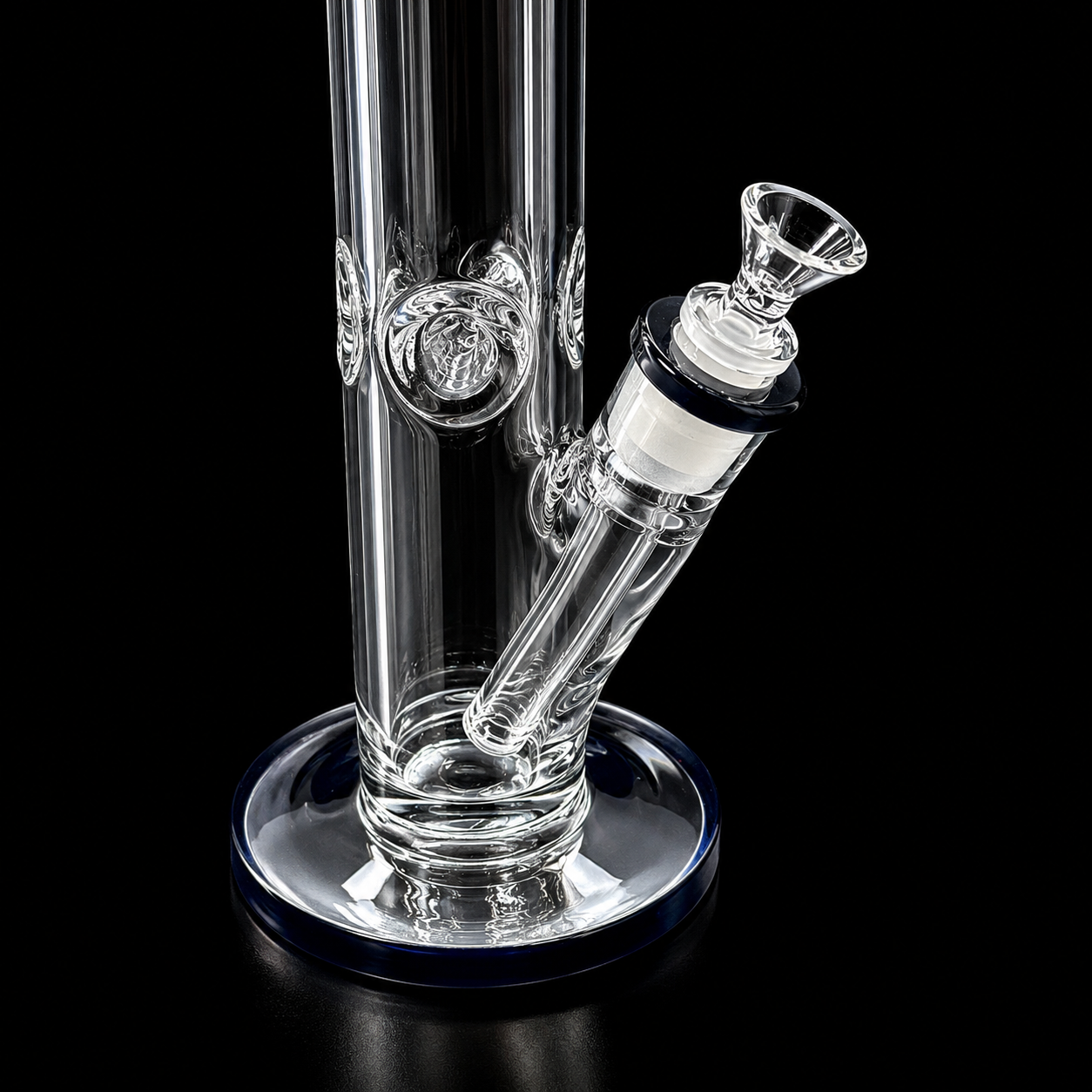 Clear glass water pipe with black accents on a black background
