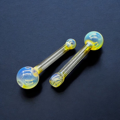 Two 5-inch fumed Pyrex glass oil burner pipes on black background – yellow and blue iridescent finish