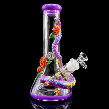 Glass smoking device with purple accents and floral decorations on a black background