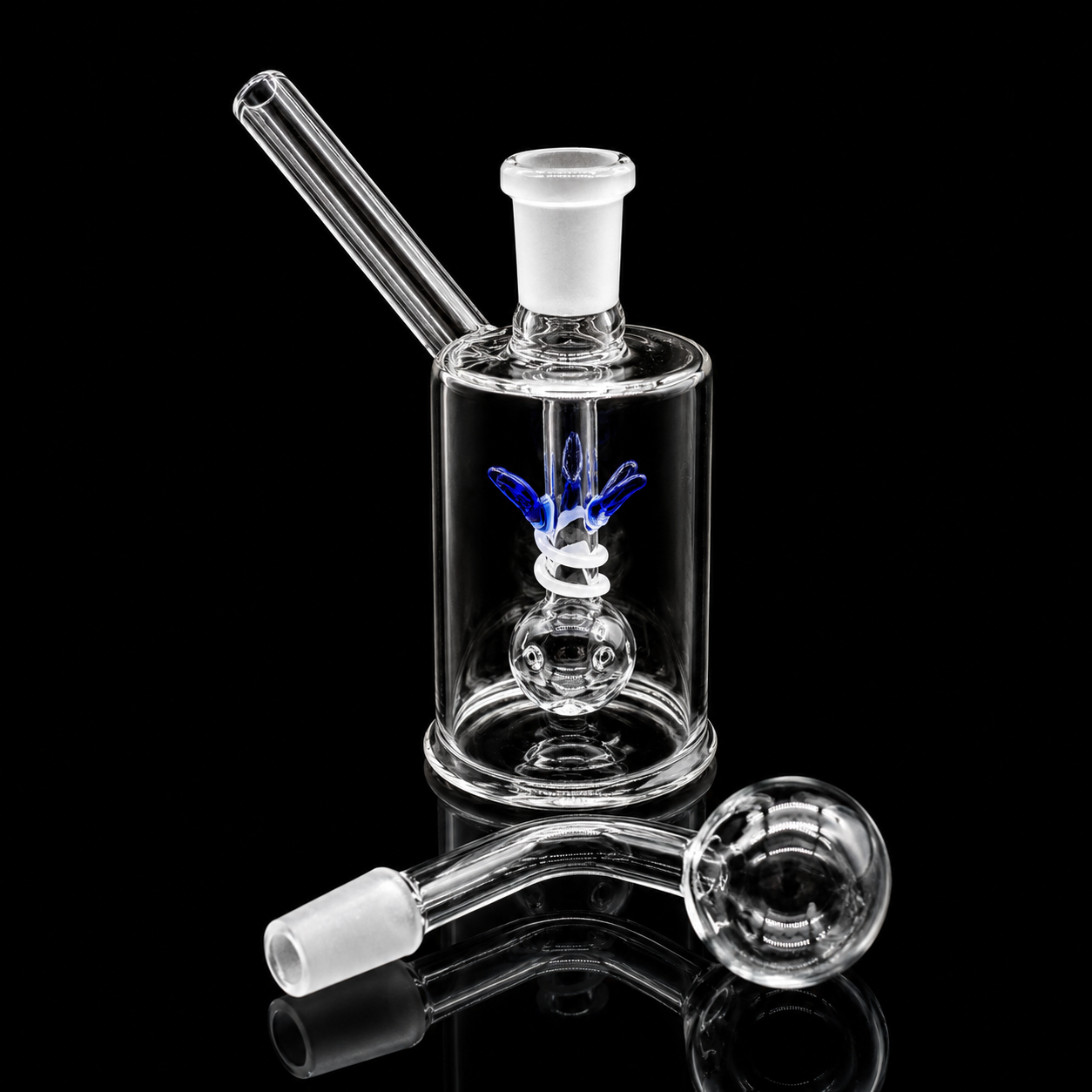 Clear glass smoking device with attachments on a black background