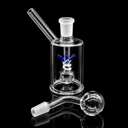 Clear glass smoking device with attachments on a black background