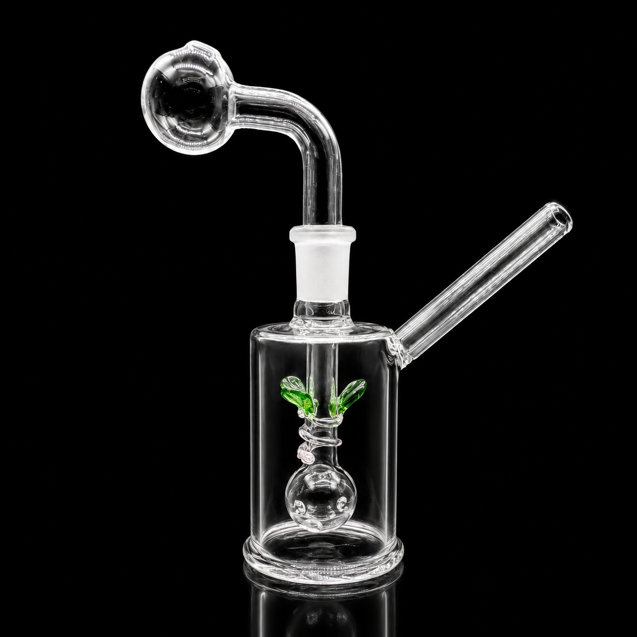 Clear glass smoking device with a small plant inside on a black background