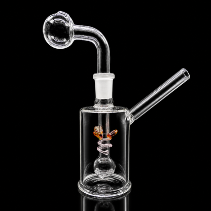 Clear glass water pipe with spiral design on a black background