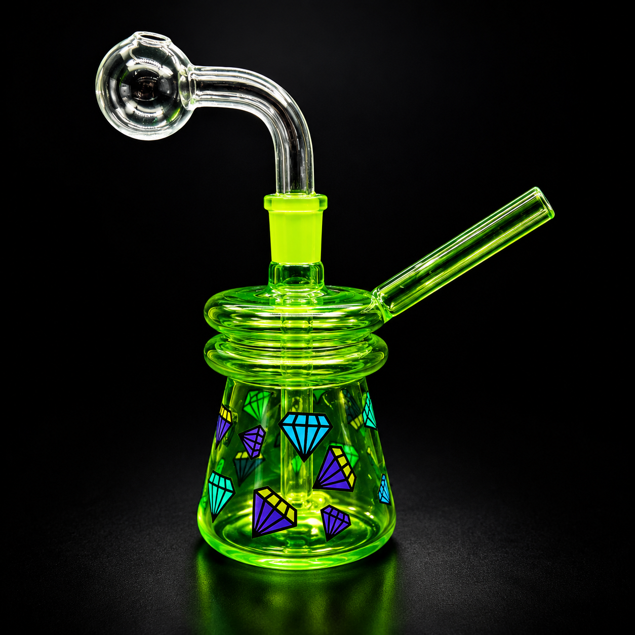 Green glass smoking device with geometric patterns on a black background