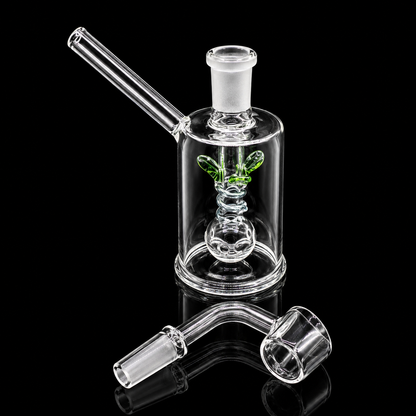 Glass smoking device with a green butterfly decoration on a black background