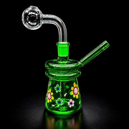 Green glass smoking device with floral designs on a black background