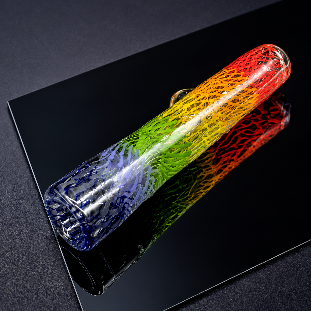 Colorful glass bottle on a black reflective surface