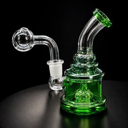 Green glass water pipe on a black background