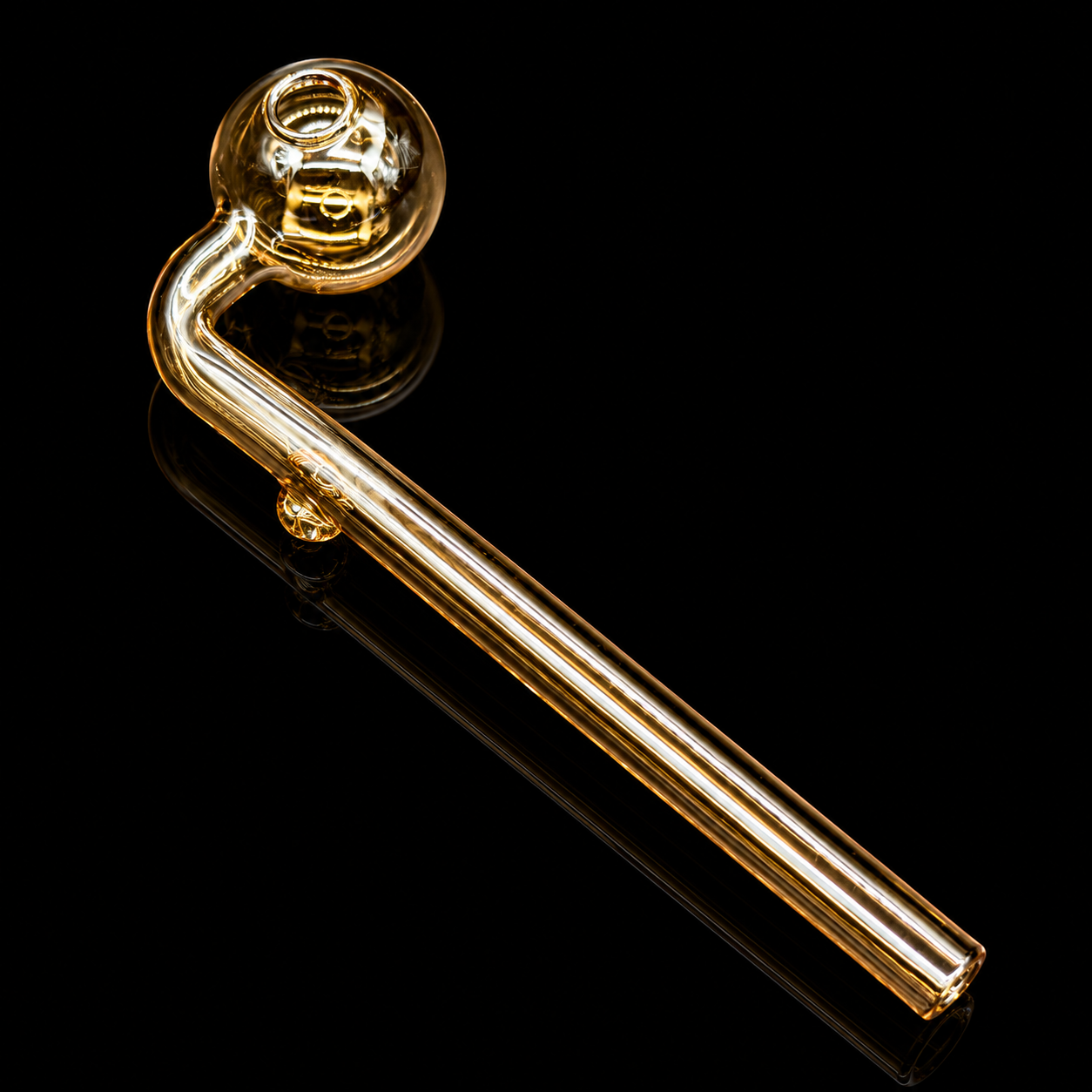Gold-colored glass pipe on a black background