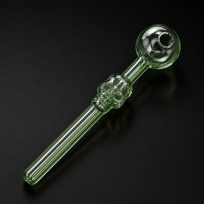 Glass smoking pipe with skull design on a black background