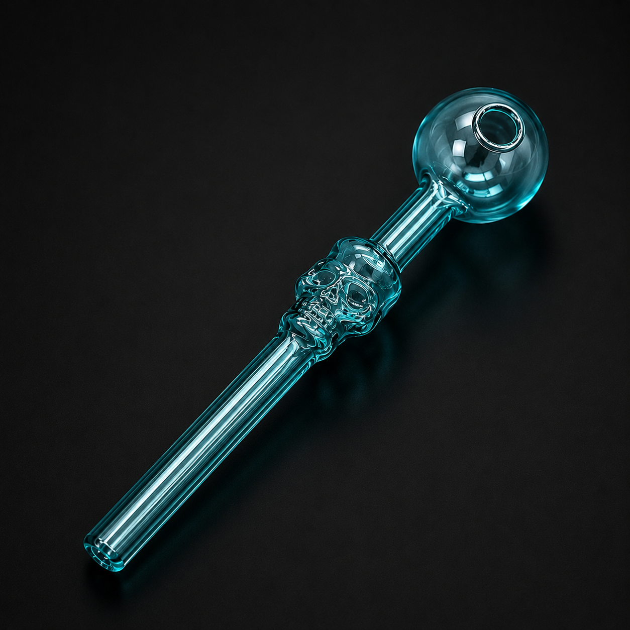 Clear glass pipe with skull design on a black background