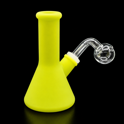 Yellow silicone smoking device with glass bowl on a black background