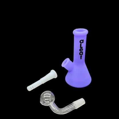 Purple glass smoking device with accessories on a black background