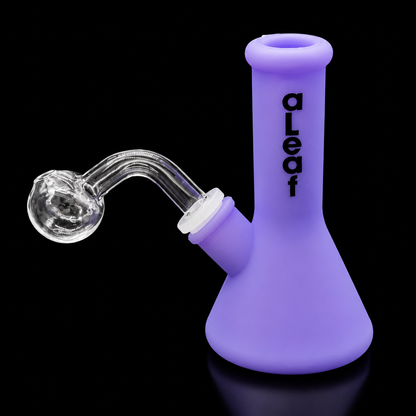 Purple smoking device with glass piece on a black background, branded 'aLeaf'.
