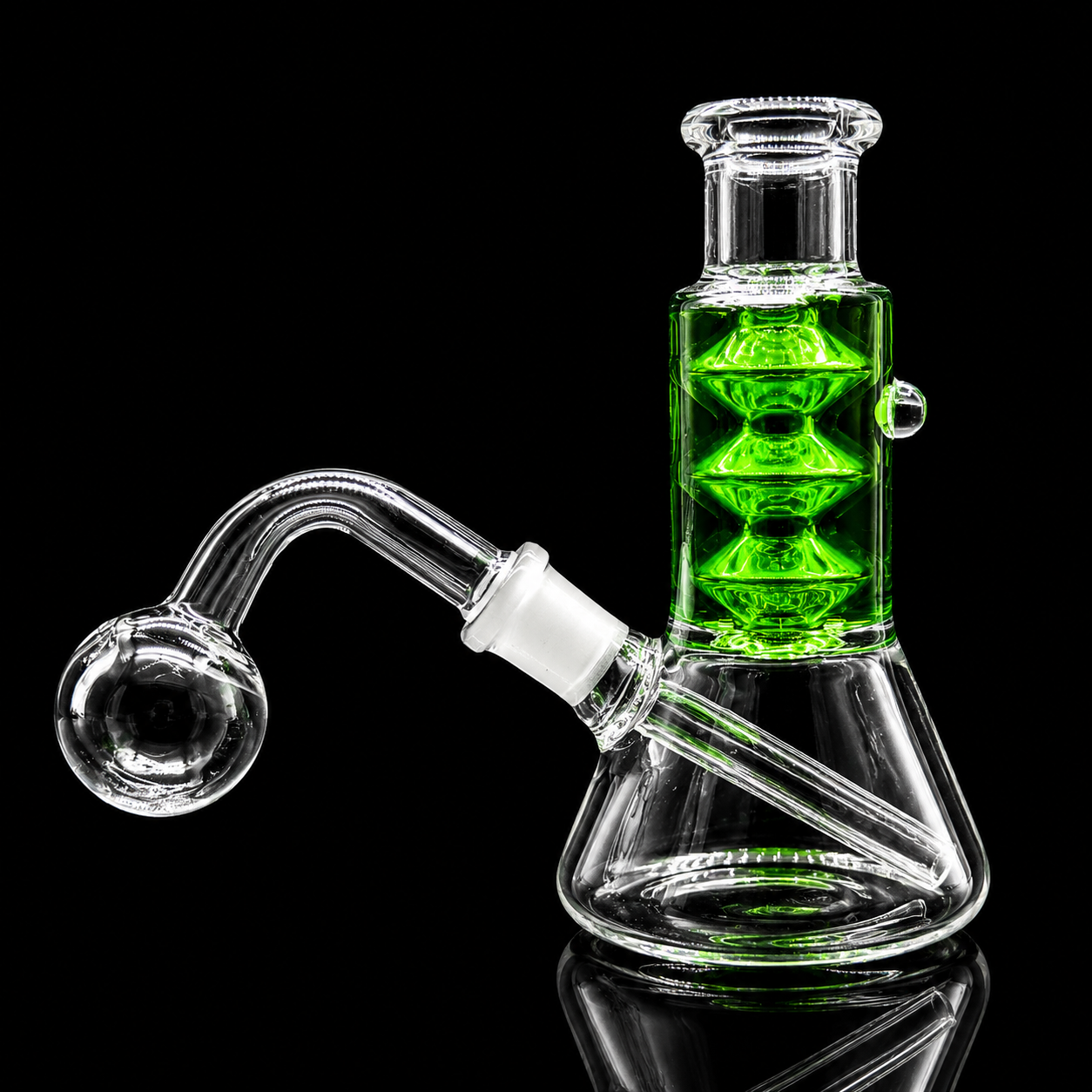 Clear glass water pipe with a bright green internal chamber and a curved glass bowl attachment, photographed on a black reflective background.