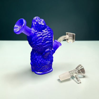 Blue glass smoking device with two attachments on a light gray surface.