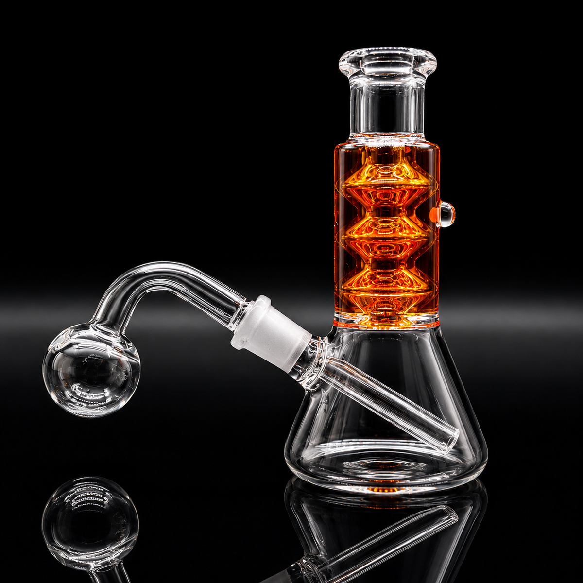 Clear glass beaker-style water pipe with an angled bowl and a tall central chamber filled with orange liquid, shown on a black reflective background.