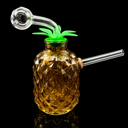 Pineapple-shaped glass smoking device with a green top on a black background