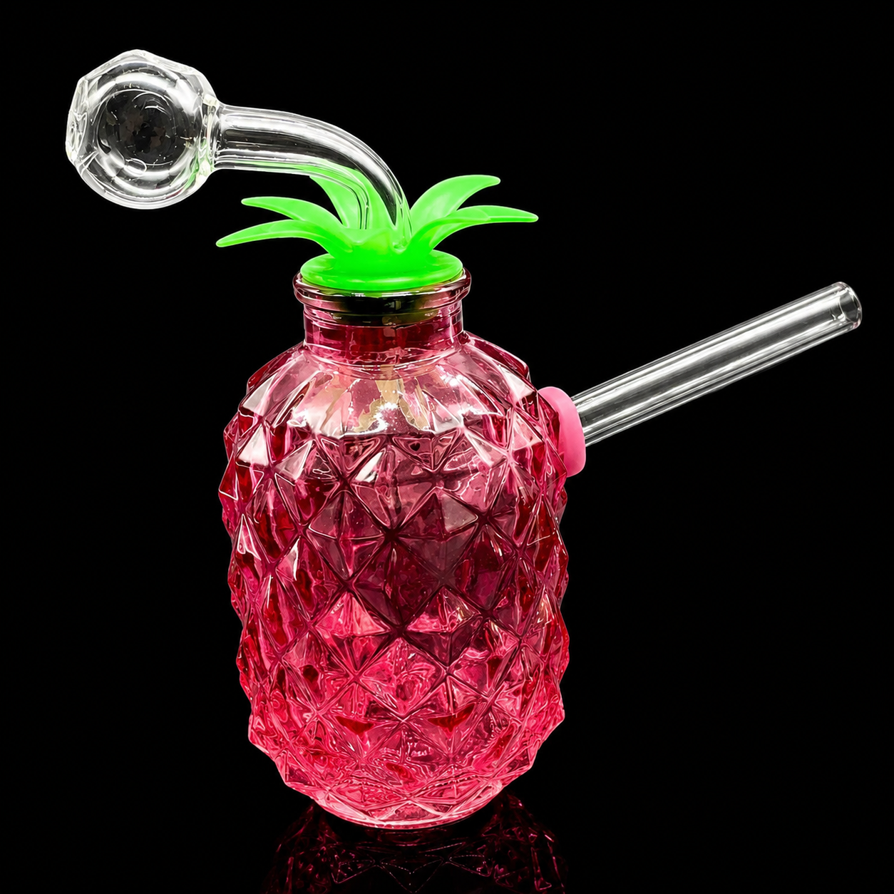 Glass pineapple-shaped drink container with a green top and pink body on a black background
