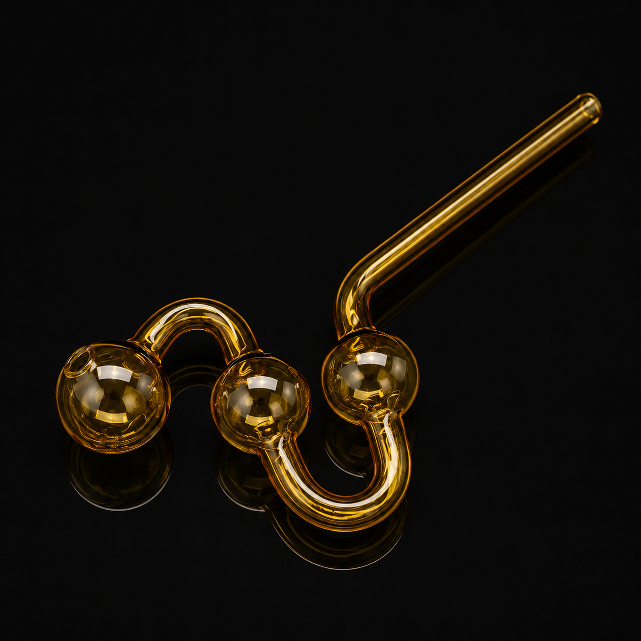 Gold-colored glass smoking accessory on a black background