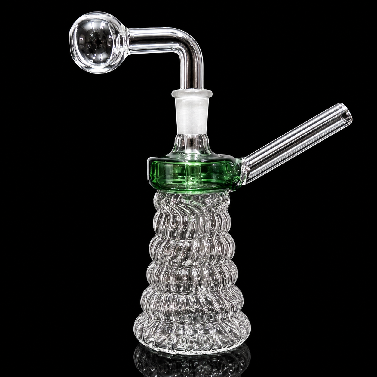 Glass water pipe with ribbed base on a black background