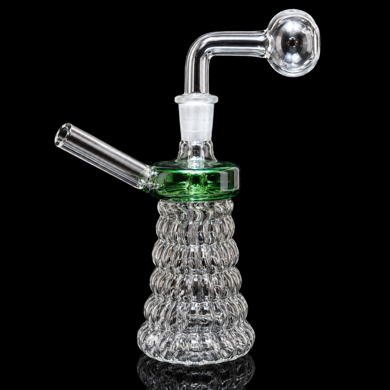 Glass water pipe with ribbed base on a black background