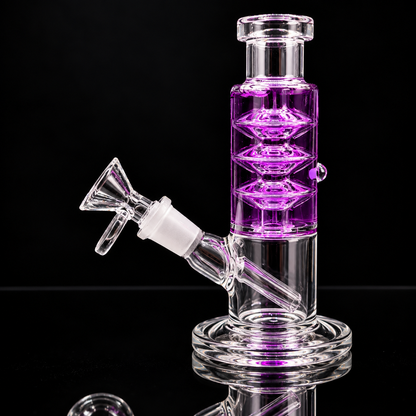 A clear glass water pipe with a purple glass chamber and a white silicone mouthpiece, shown on a reflective black background.