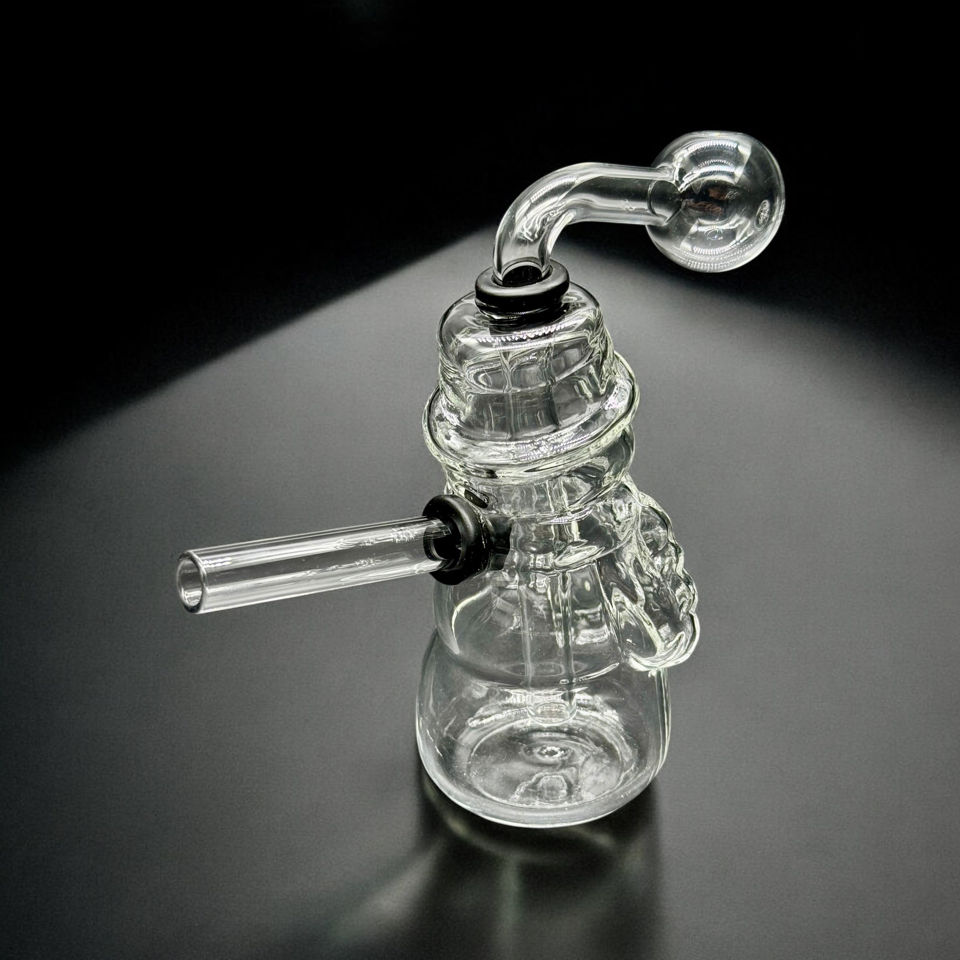 Top-down angled view of snowman oil burner glass bubbler with detachable parts and holiday-inspired design