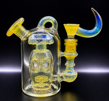 Glass smoking device with yellow and blue accents on a black background