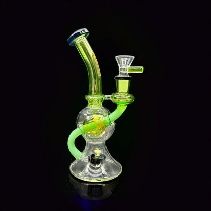 Glass water pipe with green and clear design on a black background