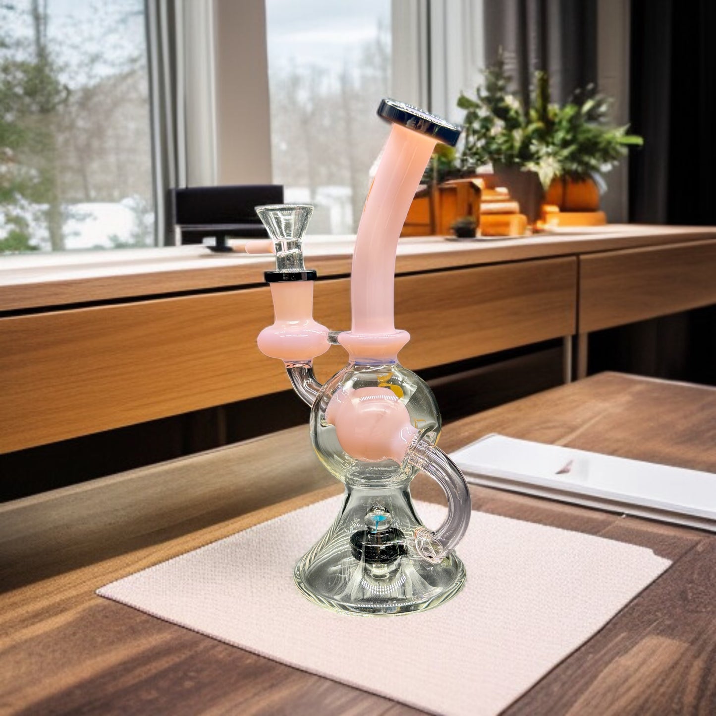 Glass smoking device on a wooden table with a blurred indoor background