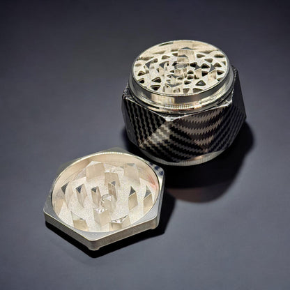 Metallic grinder with intricate design on a dark background