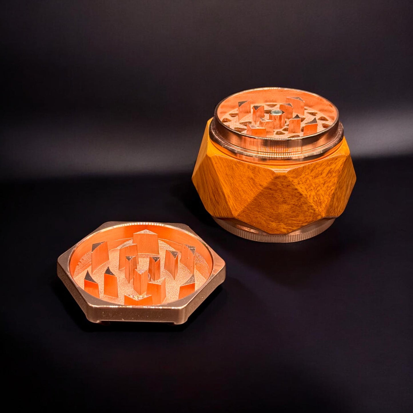Wooden grinder with metallic accents on a dark background