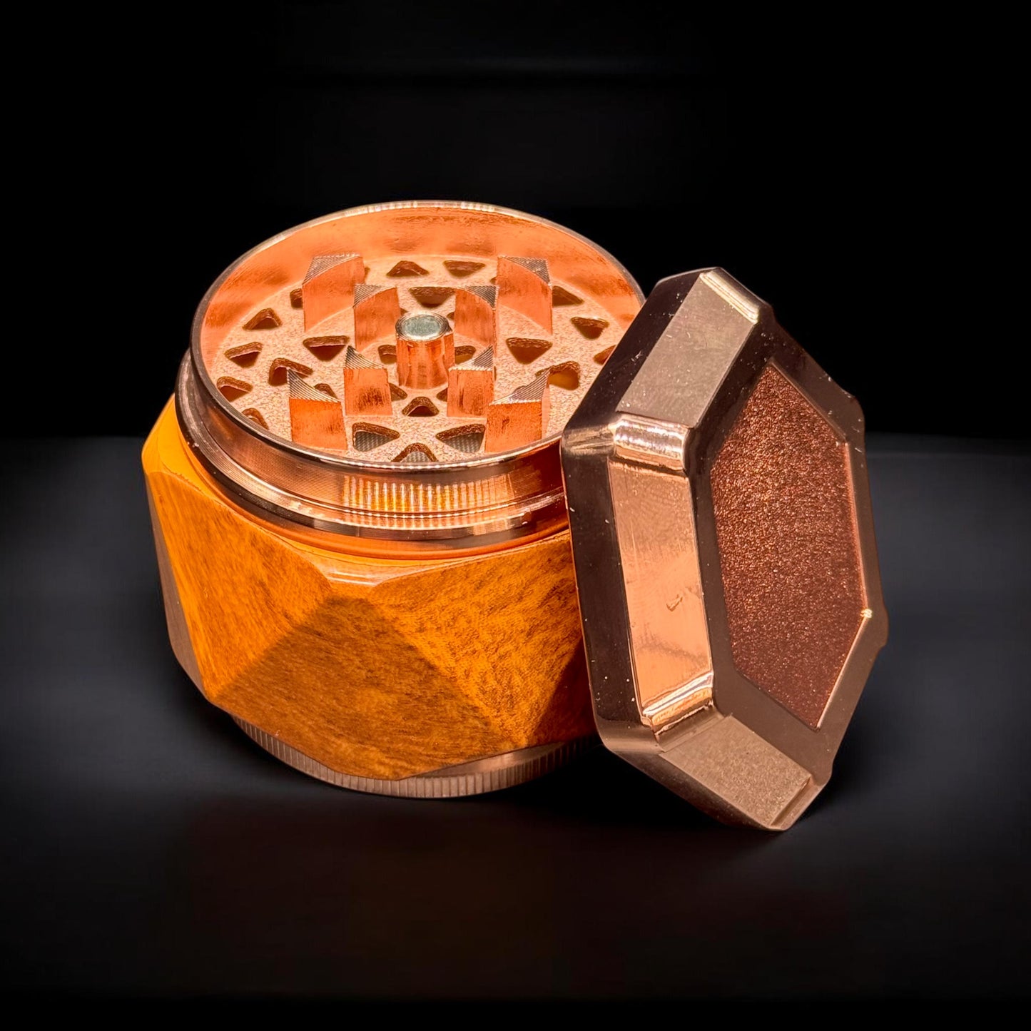 Bronze-colored metal grinder on a black background