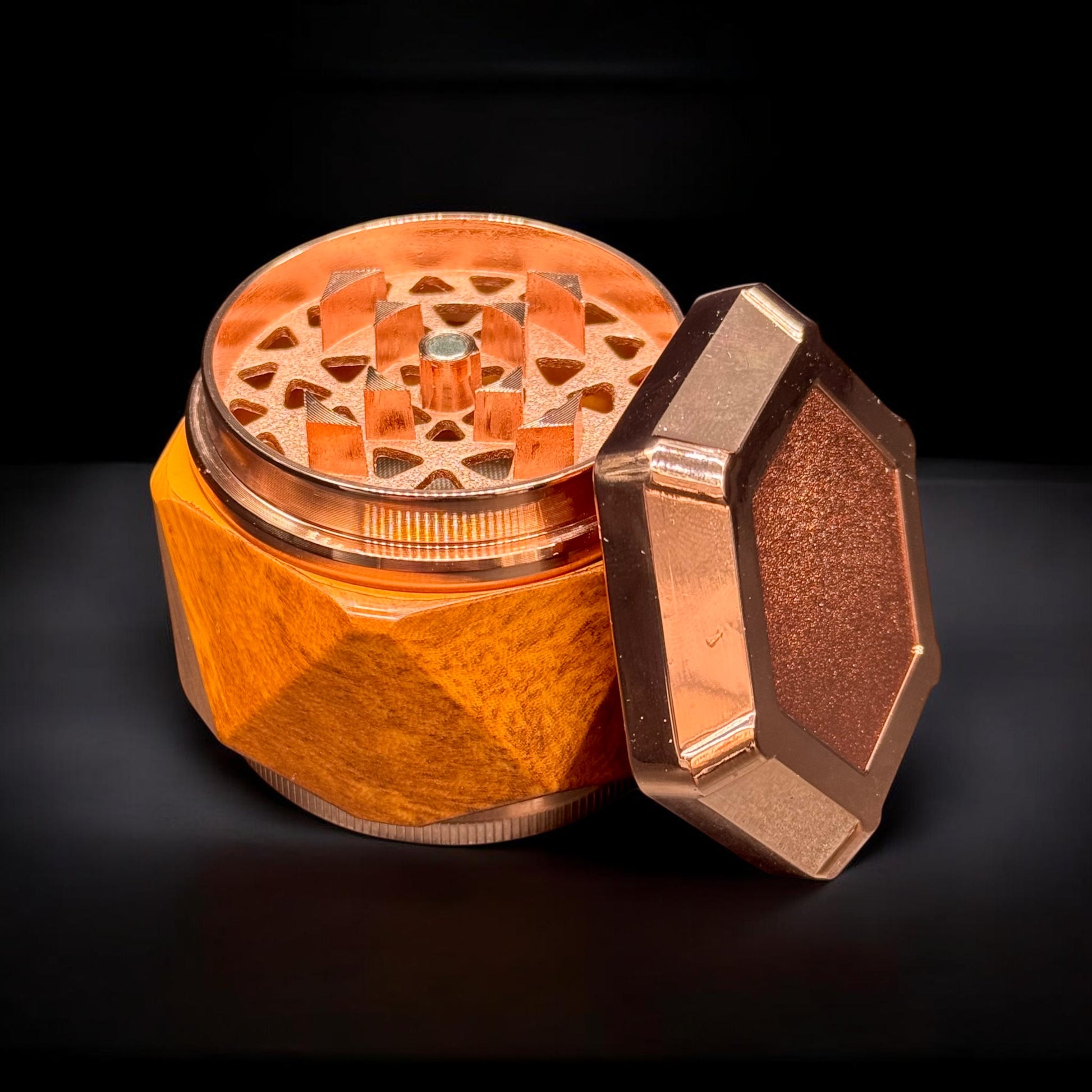 Bronze-colored metal grinder on a black background