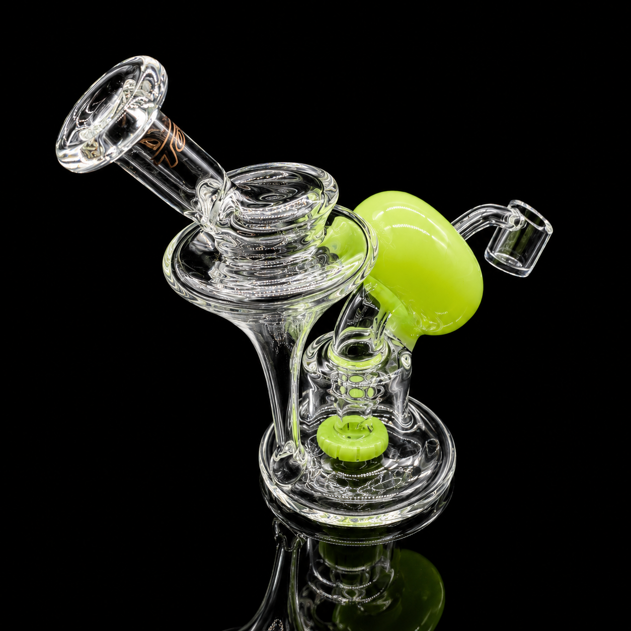 Clear glass smoking device with green accents on a black background